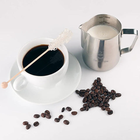 Stainless Steel Milk Frothing Pitcher 12oz 350ml With Dual Inside Measurement Scales For Precise Pouring And Latte Art next to coffee cup