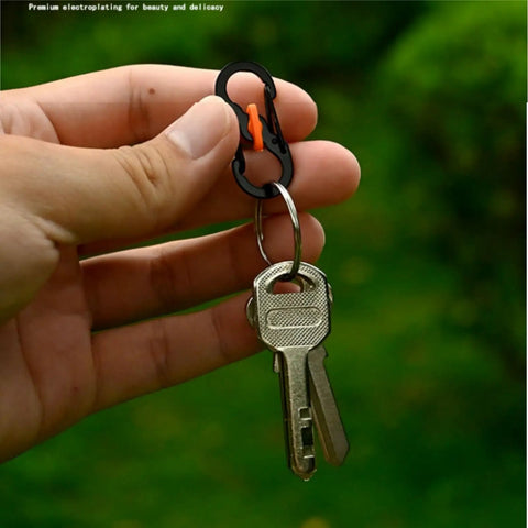 Hand holding black and orange heavy duty zipper lock clip with keys, ideal for everyday use and secure attachment, Lock It Down Tight With These 10 Heavy Duty Zipper Lock Clips Keep Your Backpack Secure Quick Disconnect Buckles For Travel School Hiking And Daily Rigs Slick Smooth Operation.