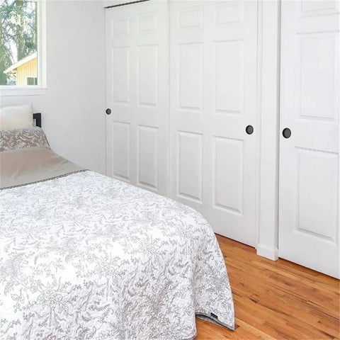 Bedroom with white sliding doors featuring Matte Black Steel Closet Door Finger Pull Set, Slick Low Profile Recessed Sliding Door Handles