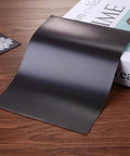 10 Pack Large Magnetic Sheets 9.3 By 6.85 Inches for die storage and crafting shown on wooden surface next to book