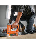18V Cordless Crown Stapler With Three Eighth Inch Heavy Duty Fasteners And Two Point Oh Amp Hour Battery Charger Kit Featuring Dry Fire Lockout LED Spotlight in use on floor.
