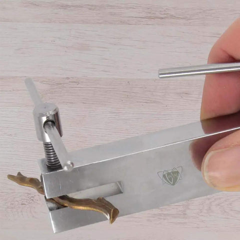 Close-up of Dual Tip Hole Punch Tool 1.5mm And 2mm in use, punching metal for crafts and DIY projects, focusing on tip and device detail.