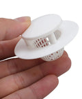 Thonlai Plastic Bathtub Drain Strainer Set of 6 held in hand, white plastic hair stopper for drainage protection.