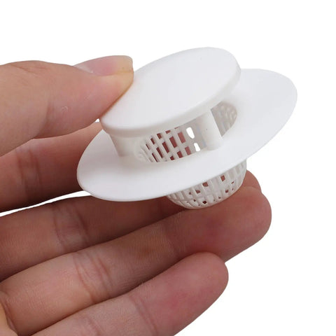 Thonlai Plastic Bathtub Drain Strainer Set of 6 held in hand, white plastic hair stopper for drainage protection.