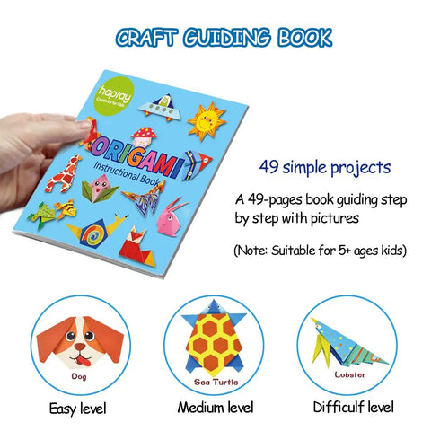 Hand holding origami instructional book from Origami Kit For Kids Ages Five To Twelve With Guiding Book 98 Double Sided Sheets And 47 Pattern Designs 14 By 14 Cm Paper For Beginners Craft Projects And An Awesome Gift For School.