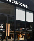 Glass storefront with matte black frame and wooden door handles, suitable for glass, wood, or metal doors in cafes or shops.