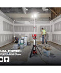 2136-20 Cordless Tripod Light For 18V M18 Rocket System illuminating a construction site with workers, adjustable to 7 feet