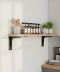Triangular Steel Shelf Brackets For Floating Desks And Wall Shelves supporting kitchen shelf with spices and utensils.