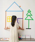 Child creating wall art with Rainbow Masking Tape Set With Twelve Rolls Of Colorful Painter Tape One Inch By Seven Hundred Twenty Feet Each