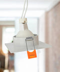 Lawsen Spring Clips Recessed Lighting 100 Pcs Spring Snap Downlight Clips securing a white LED ceiling light panel with orange clip.