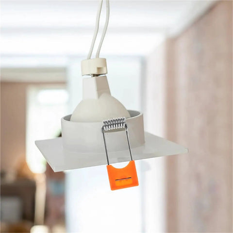 Lawsen Spring Clips Recessed Lighting 100 Pcs Spring Snap Downlight Clips securing a white LED ceiling light panel with orange clip.