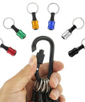 1/4 Inch Hex Shank Bit Holder Keychain for Drill Bits portable aluminum alloy with belt clip, colored attachments, held in hand.