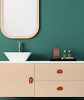 Dope Set Of 4 Agate Slice Drawer Knobs With Screws, geode crystal cabinet pulls on beige bathroom cabinet against green wall.
