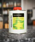 Top-Shelf Solvent-Based Dense Stone Sealer For Granite Porcelain And Polished Concrete With Killer Stain And UV Protection That Repels Oil And Water Like A Champ And Fast Curing Formula In 1 Liter Bottle on a kitchen counter.