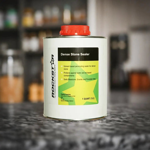 Top-Shelf Solvent-Based Dense Stone Sealer For Granite Porcelain And Polished Concrete With Killer Stain And UV Protection That Repels Oil And Water Like A Champ And Fast Curing Formula In 1 Liter Bottle on a kitchen counter.