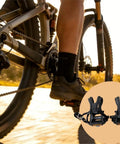 Cyclist on bike with Extra Wide Bike Pedals With Toe Clips And Straps, Nine Sixteenths Inch Oversized Platform for MTB and indoor cycling