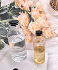 Glass bottles with liquid on a table with roses, featuring black caps, related to 80 Pieces Silicone Hole Plugs Kit With 7 Sizes.