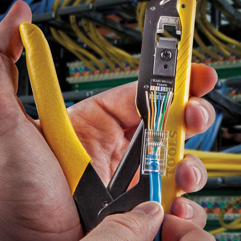 Hand using RJ45 Ethernet Cable Tester And Crimper Kit With Pass Thru Technology for Cat5e and Cat6 terminations, connectors included