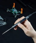 Hand holding Ts101 Portable Soldering Iron With PD And DC Dual Power, 50-400 C Adjustable, near circuit board and drone