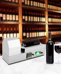 Fast Heat Electric Bottle Sleeve Shrinker Machine With Digital Temp Control For Wine Capsules Up To 70 Millimeters on countertop with wine bottle.