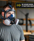 Man wearing Workhorse Full Face Respirator Mask for Work and Survival, dual filters, EN136 CL2 certified, in a workshop.