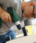 Man using a power drill with focus on the 30 Piece Tungsten Carbide Micro PCB Drill Bit Set With 0.3mm And 1.2mm Shanks For Precision PCB Drilling CNC Engraving And Rotary Tool Projects Ultra Tough Wear Resistant Tungsten Steel For Circuit Boards