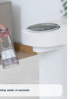 Zero Drama Instant Boiling Water Dispenser And Rapid Chill Formula Preparation Machine for baby bottle prep, showing a user holding water container.