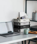 Stackable Cream Plastic Storage Bin Set For Desk Or Vanity Heavy Duty Organizer Box With Straight Walls Small Tote Bins For Storage 12 By 8 By 3 Inches 0.5 Gal 1 Pack Durable Space Saving Desk Organizer shown on a desk.