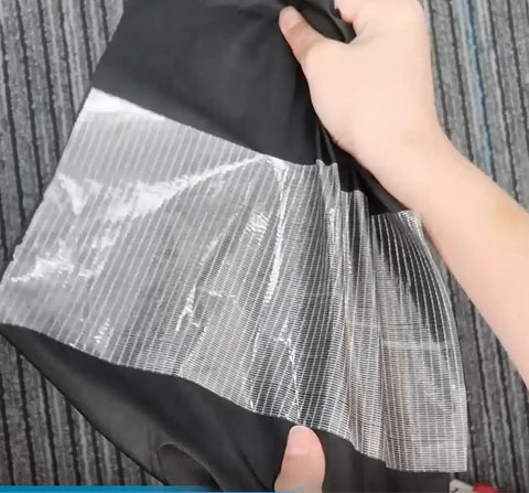 Heavy Duty Waterproof Repair Tape Kit For RV Awnings Tents Tarps Boat Covers Sail Fabric And More being applied to fabric
