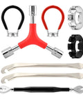 No Sweat Road Warrior Bike Repair Kit Featuring Five Universal Spoke Wrenches Two Heavy Duty Tire Levers And One Y Shaped Socket Adapter showing tools laid out.