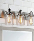 Dope Brushed Nickel Three Light Bath Vanity Wall Sconce With E26 LED Bulbs over bathroom mirror.