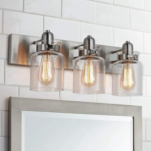 Dope Brushed Nickel Three Light Bath Vanity Wall Sconce With E26 LED Bulbs over bathroom mirror.