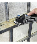 5 Amp Tool-Less Oscillating Tool Kit With Accessory Set For Cutting Sanding Grinding And Scraping in use on window frame