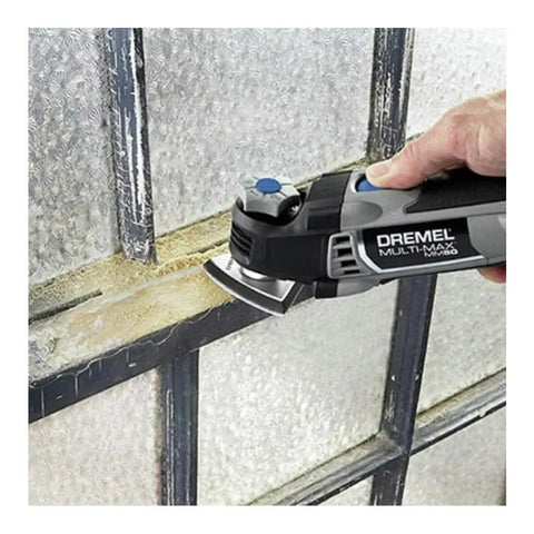 5 Amp Tool-Less Oscillating Tool Kit With Accessory Set For Cutting Sanding Grinding And Scraping in use on window frame