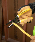 Person using Dual NM Cable Stripper And Cutter For 12 And 14 AWG Wire, Strips 12/2 And 14/2 Outer Jacket, in construction setting