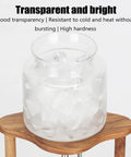 Top Shelf Cold Brew Coffee Maker With Clear Glass Carafe And Sturdy Wood Base showing clear glass jar filled with ice.