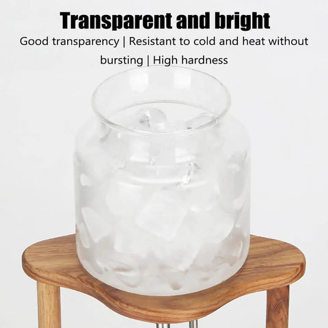 Top Shelf Cold Brew Coffee Maker With Clear Glass Carafe And Sturdy Wood Base showing clear glass jar filled with ice.