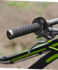 Close-up of a mountain bike handlebar with black grip and brake lever, focus on handle and lever setup, no washers visible.