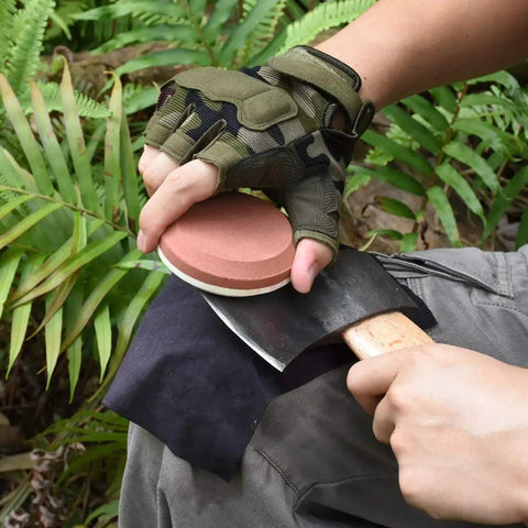 Using Dual Grit Whetstone Puck For Axe Hatchet And Knife Sharpening With Sheath on an axe outdoors.