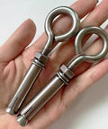 2 Pack M8 Stainless Steel Expansion Eyebolts Heavy Duty Beefy Shoulder Lag Ring Bolts Lifting Hardware With Nut For Wall Ceiling Concrete Masonry Anchors Rustproof Durable Construction Built To Last For Heavy Lifts in hand.