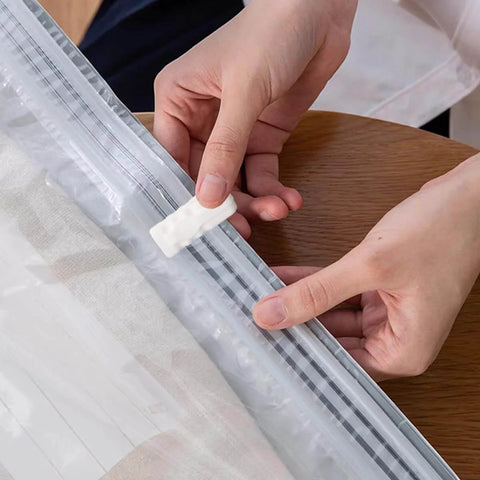 Person sealing vacuum bag with 30 Pack Vacuum Storage Bag Sealing Clips Quick Snap Zipper Grips Reusable Bag Sealer