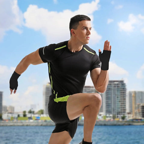 Man running by waterfront wearing Four Pack Palm Brace Wrist Support Sleeves For Men And Women, All Day Comfort, Carpal Tunnel Relief, Compression Gloves For Hand Pain, Fitness And Sports Gear, Black And Nude, Size 3.5 To 4.3 Inches, black color.