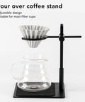 Heavy Duty Aluminum Pour Over Coffee Stand Adjustable Height And Angle Portable Dripper Holder with a glass carafe on a black base.