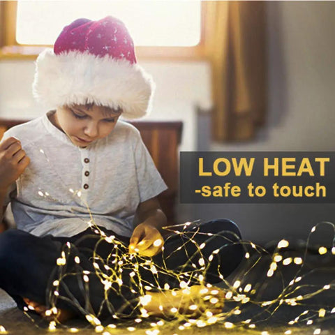 Child holding 4 Pack 33 Feet 100 Warm White LED Fairy Lights Battery Operated With Remote Control Timer IP67 Waterproof