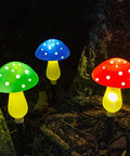 Colorful Upgraded Dope Solar Mushroom Lights for outdoors, glowing green, blue, and red with eight modes, in garden decor.