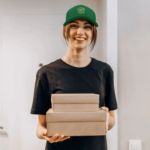 Woman wearing Green Women's Trucker Hats Bundle For Everyday Style And Dope Cap Game holding gift boxes