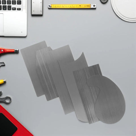 2 Set Multi Shaped Steel Card Scrapers For Woodworking And Cabinet Fixes With Comfy Grips For Quick Surface Leveling and Low Hand Strain visible on a work table.