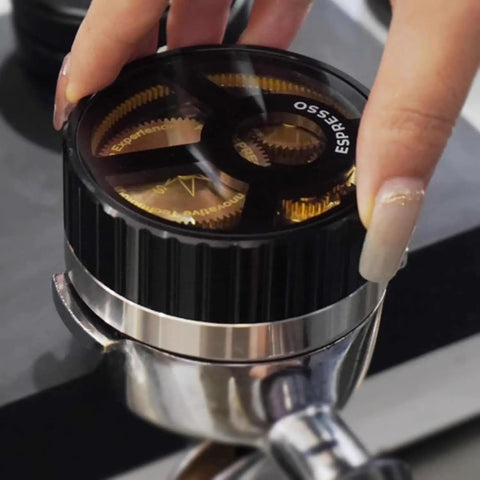 Next Level 58mm Coffee Distributor Needle With Solid Black Base Precision Gear Spin Drive, black top and stainless steel, in use.