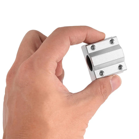 Heavy Duty SCS8UU Linear Ball Bearing Block 8mm bore held in hand, crafted from durable aluminum for CNC routers and 3D printers.