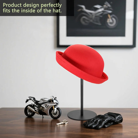 Sturdy Metal Hat Stand For Desk Or Shelf, Hat Display Holder with a red hat, set on a wooden surface next to a toy motorcycle.